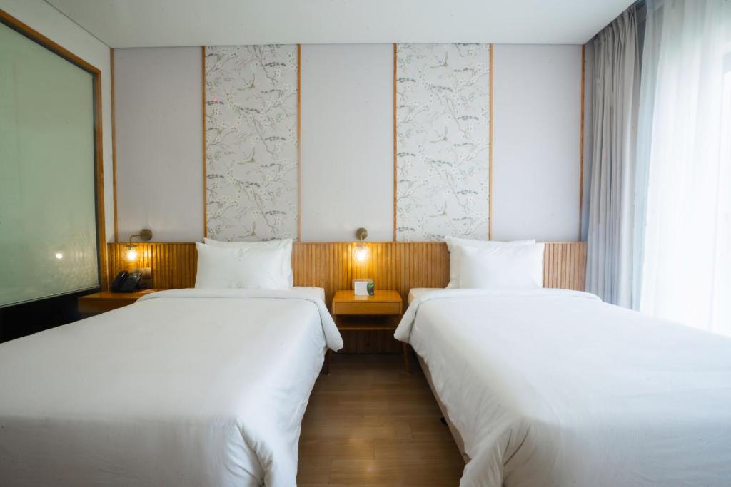 Postel nebo postele na pokoji v ubytování Seabird Hotel Thien Cam