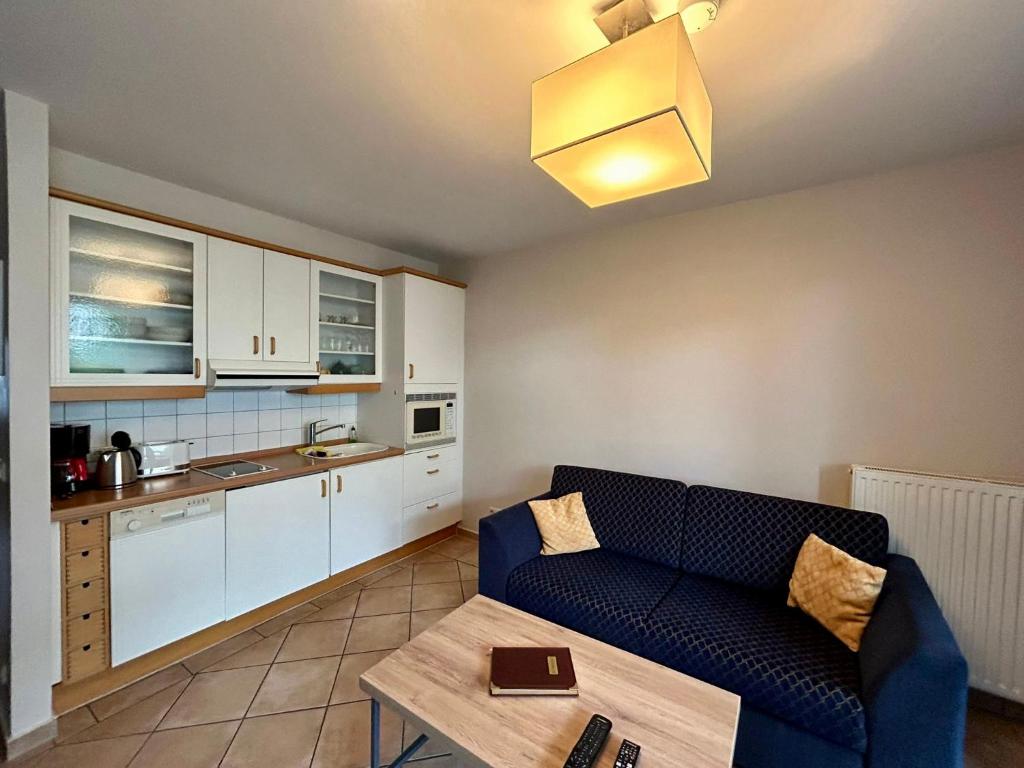a living room with a couch and a table at Ferienwohnung „mittendrin“ in Zinnowitz