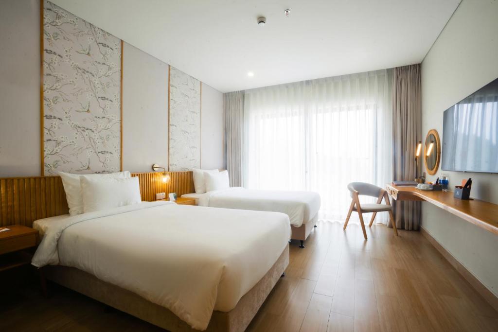 Postel nebo postele na pokoji v ubytování Seabird Hotel Thien Cam