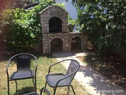 two chairs sitting in front of a stone building at Akapulkom in Čanj