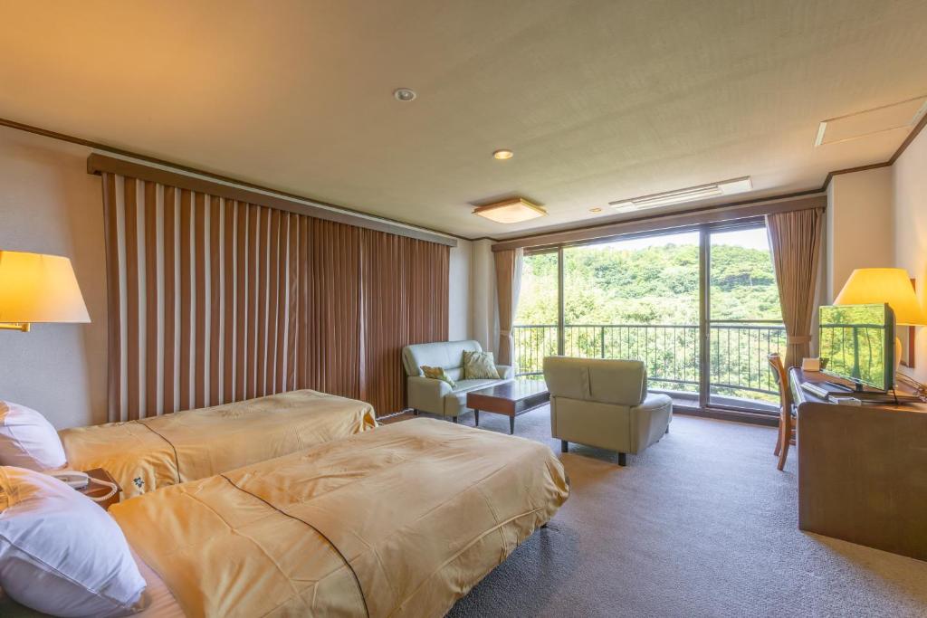 Postel nebo postele na pokoji v ubytování Atagawa Prince Hotel