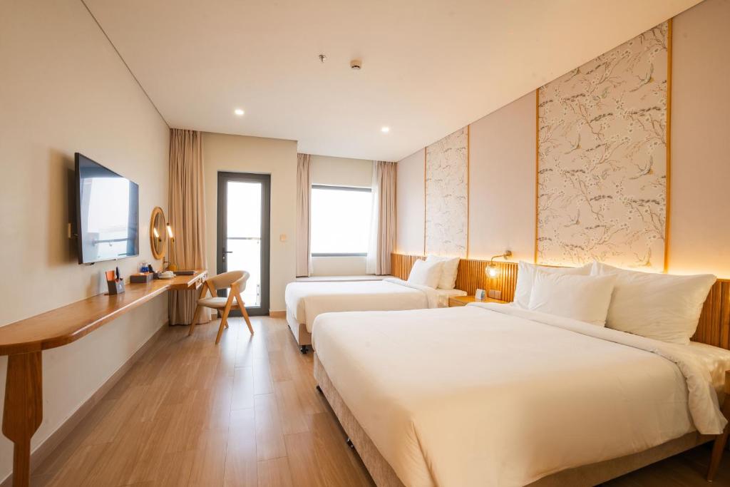 Postel nebo postele na pokoji v ubytování Seabird Hotel Thien Cam