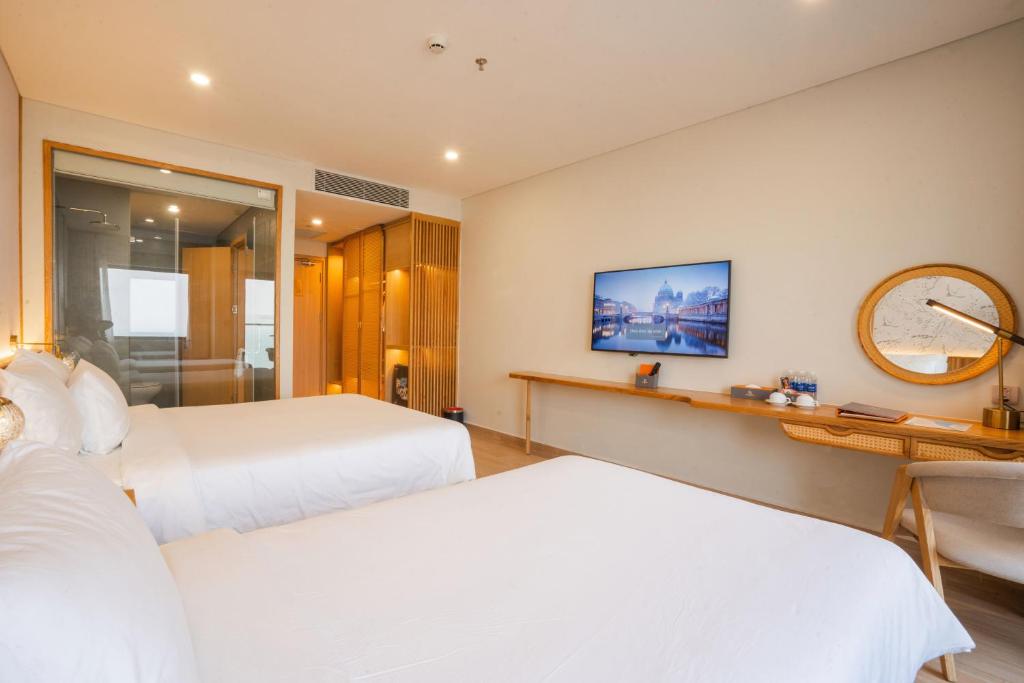 Postel nebo postele na pokoji v ubytování Seabird Hotel Thien Cam