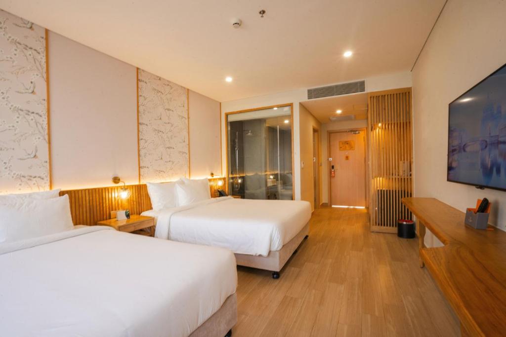 Postel nebo postele na pokoji v ubytování Seabird Hotel Thien Cam