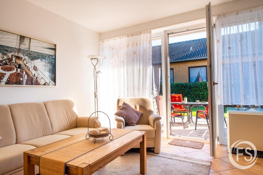 una sala de estar con un sofá y una mesa en Reihenhaus Donna, en Dahme