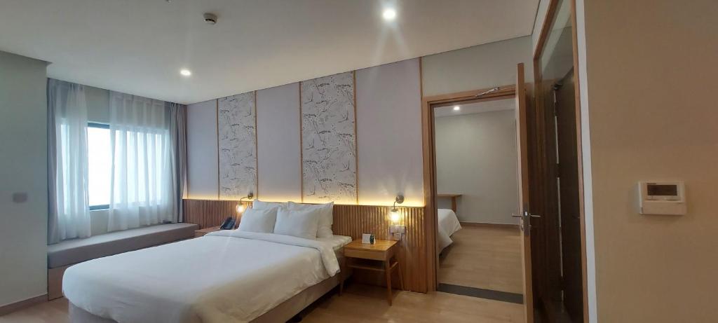 Postel nebo postele na pokoji v ubytování Seabird Hotel Thien Cam