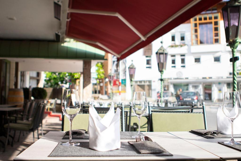 a table with wine glasses and a paper bag on it at Sporthotel Igls in Innsbruck