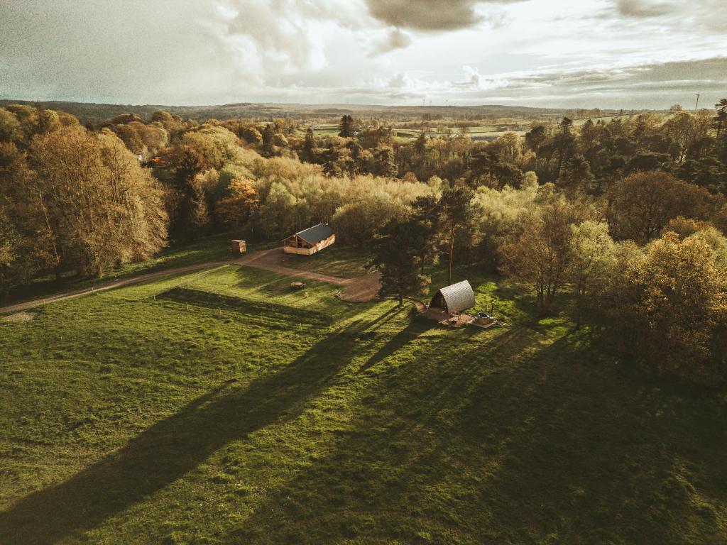 an aerial view of a field with two buildings at Tempo Manor Cabins in Tempo