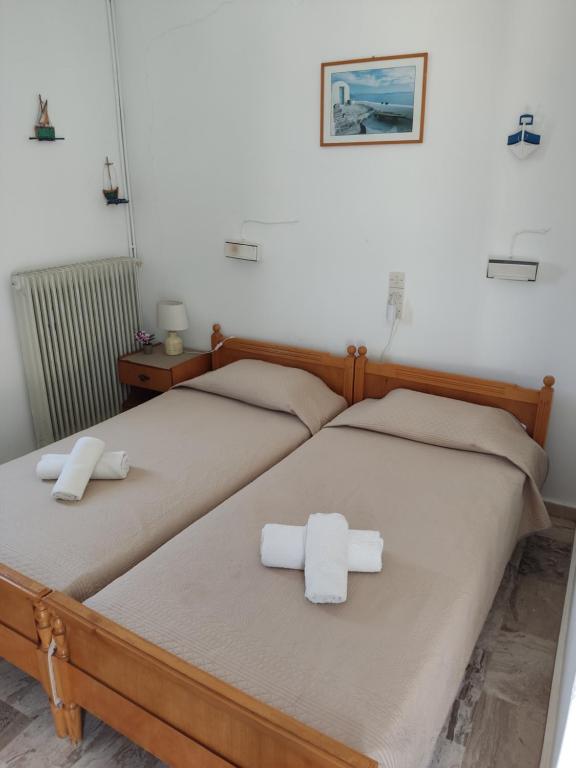 two beds in a room with towels on them at Manolis Rooms Vathys in Kalymnos