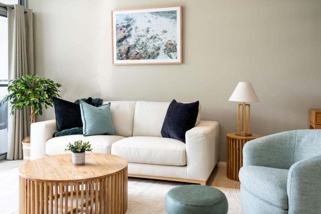 a living room with a white couch and a table at Dunn Bay Apartment 6 in Dunsborough