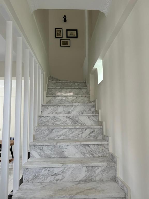 a hallway with stone stairs in a house at Mary Lo Guest House in Nydri