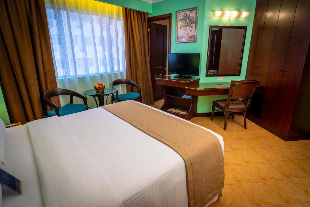 Postel nebo postele na pokoji v ubytování Royal Bellagio Hotel