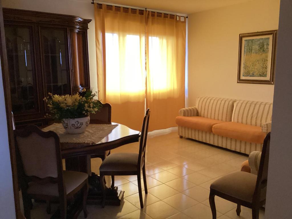 a living room with a table and a couch at La Casa per te in Pescara