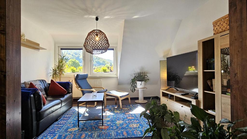 a living room with a couch and a table at Stadt-Ferienwohnung mit 55 m² für 2 erw. Personen und Kind bis 3 Jahren in Bad Lauterberg