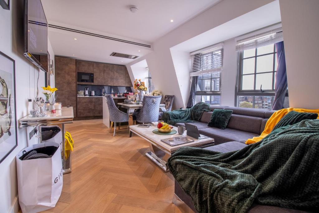a living room with a couch and a table at Marble Arch Penthouse 3 Bed in London