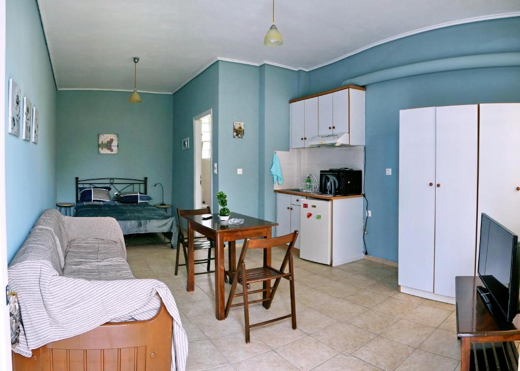 a room with a kitchen and a living room at Studios Akrotiri in Mytilini