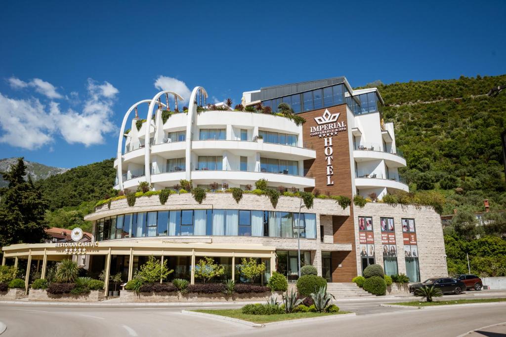 a building with people sitting on top of it at Hotel Imperial Conference & Spa in Budva