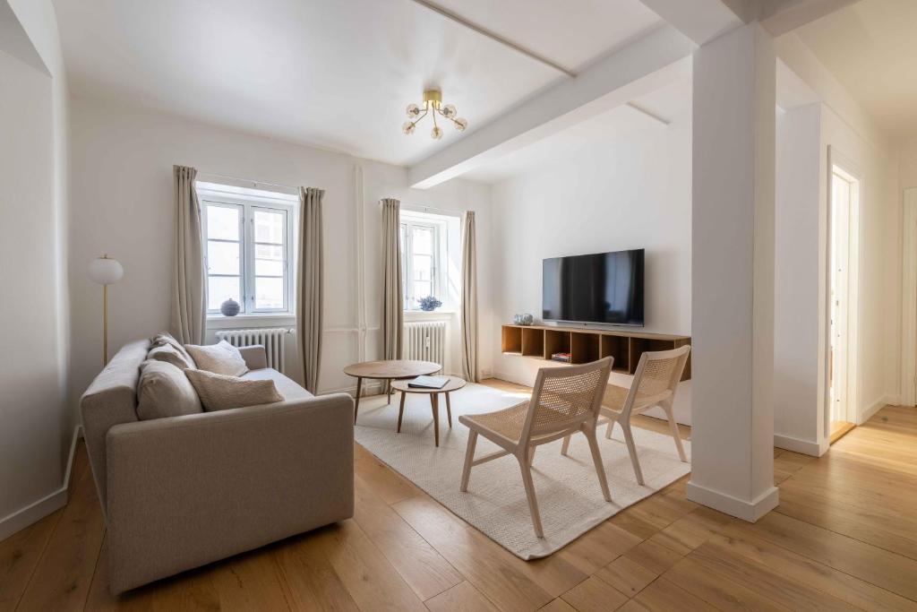 a living room with a couch and a table at Stylish Apartments in CPH City in Copenhagen