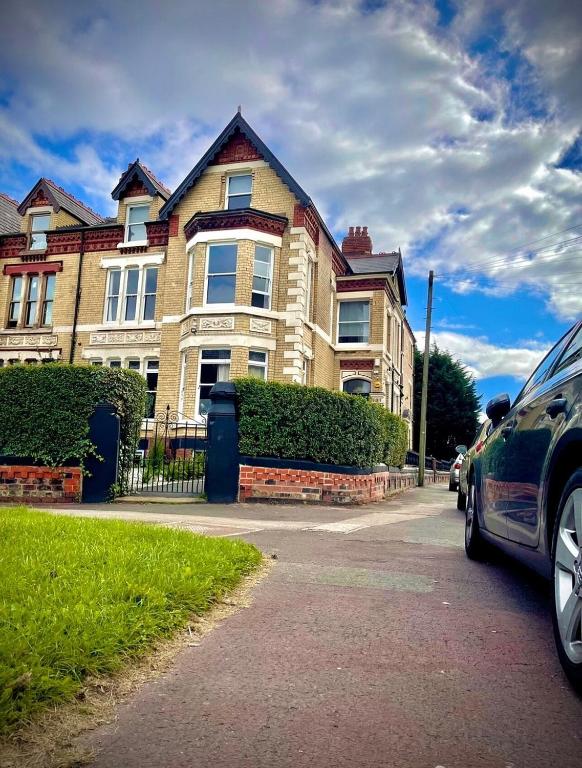 a car parked in front of a large house at Single Room Shared bathroom Free Street Parking Near Anfield LFC in Liverpool