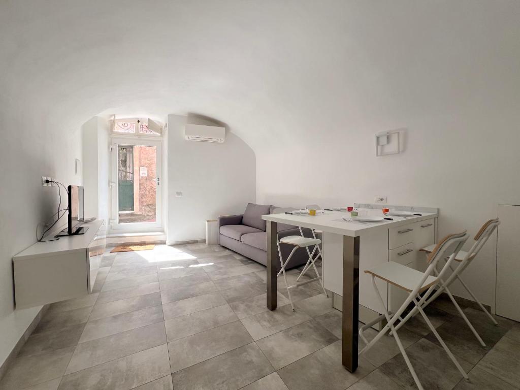 a white living room with a table and a couch at Appartamento del centro in Lerici