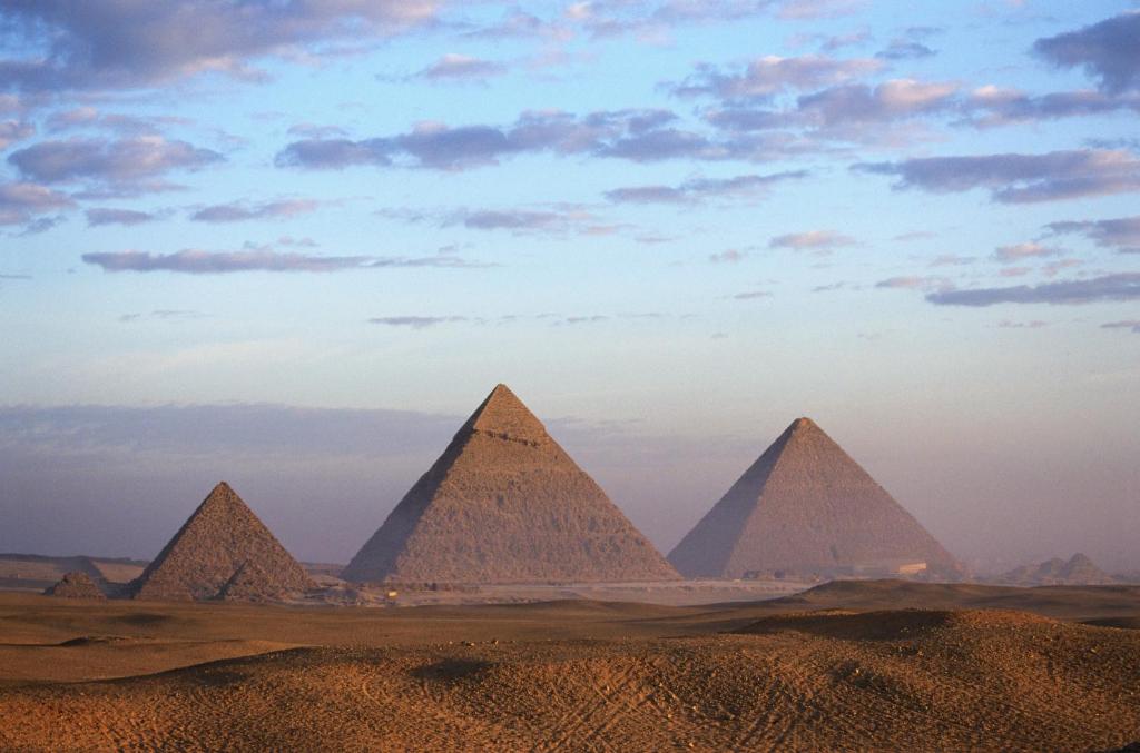 a view of the pyramids of giza at sunset at pyramids Alaaeldeinn in Cairo