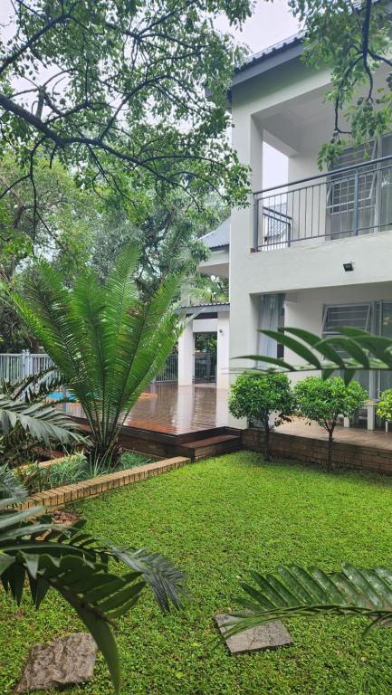 a house with a garden in front of it at Be Our Guest Self Catering in Nelspruit