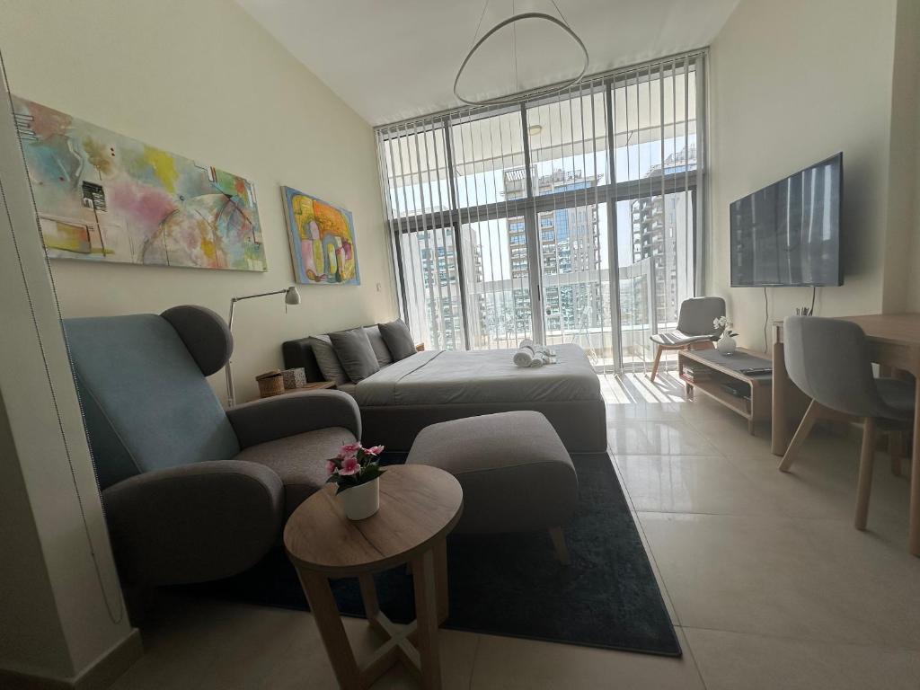 a living room with a couch and a bed at Dubai 7 in Dubai