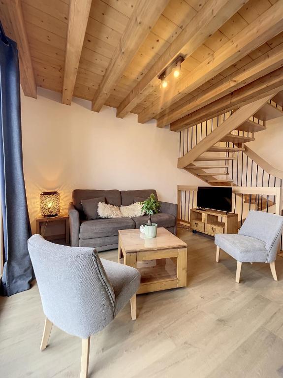 a living room with a couch and a table at Chalet L'Argentière in La Toussuire