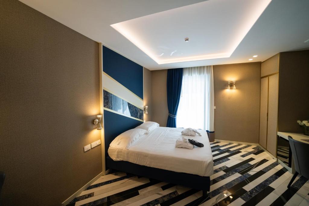 Postel nebo postele na pokoji v ubytování Hotel Cala Moresca