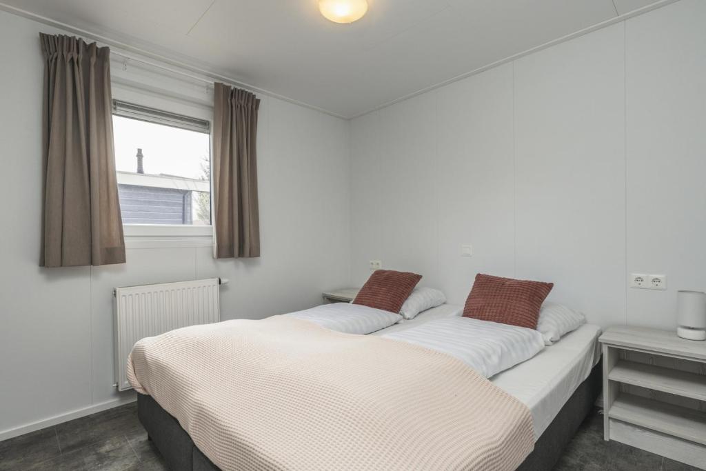 two beds sitting next to each other in a bedroom at Nature Cabin 5 p. in Zuna