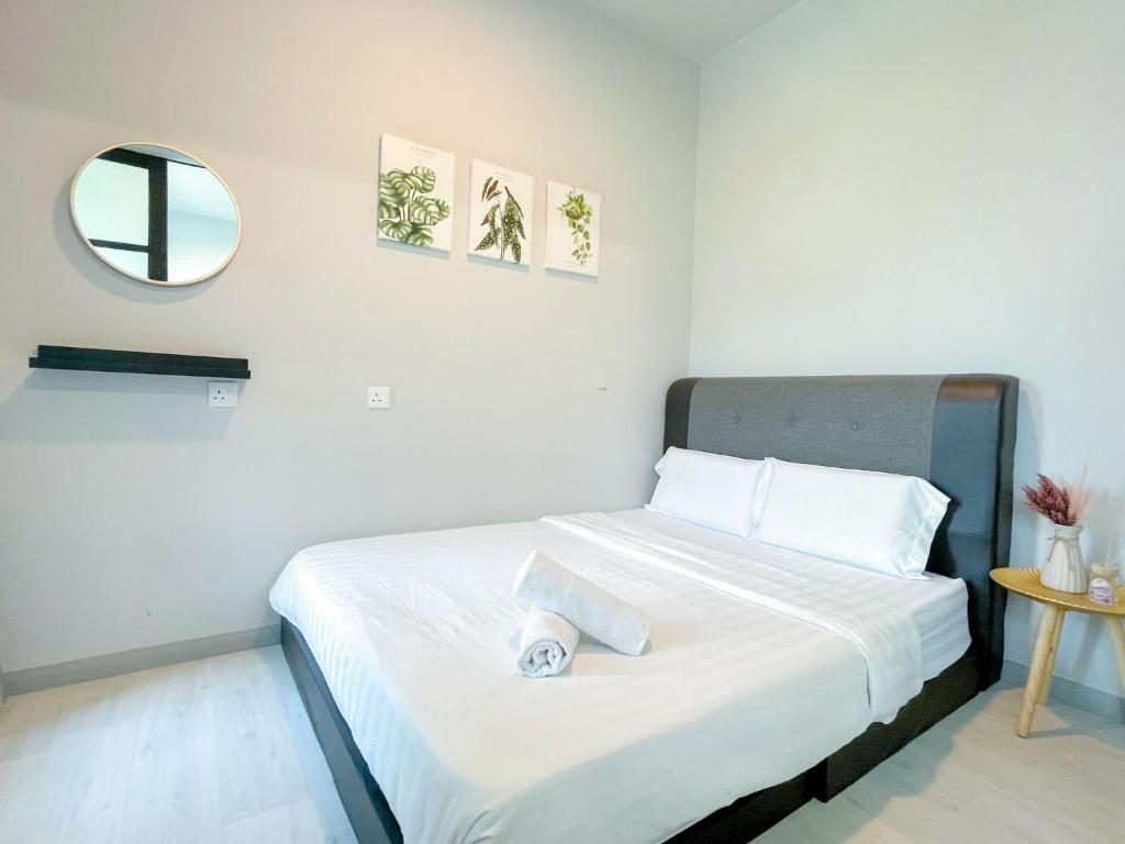 a white bedroom with a bed with a mirror at SUMMER CHRlSTMAS JESSELTON QUAY in Kota Kinabalu