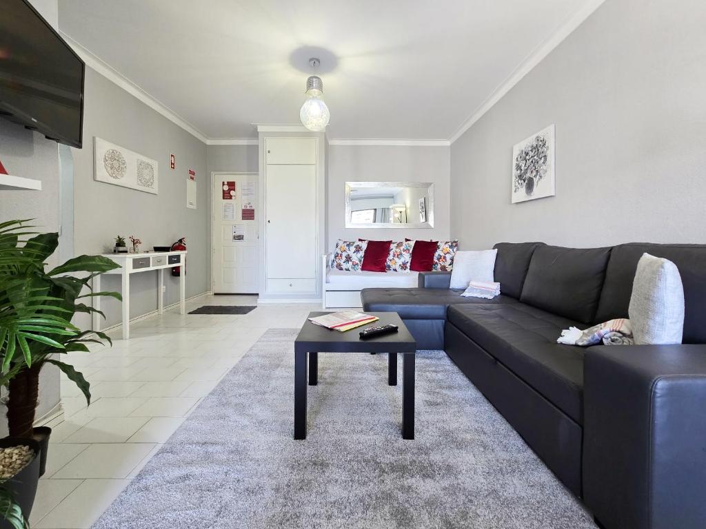 ポルティマンにあるApartment Praia Rocha Cinzaのソファとテーブルのあるリビングルーム