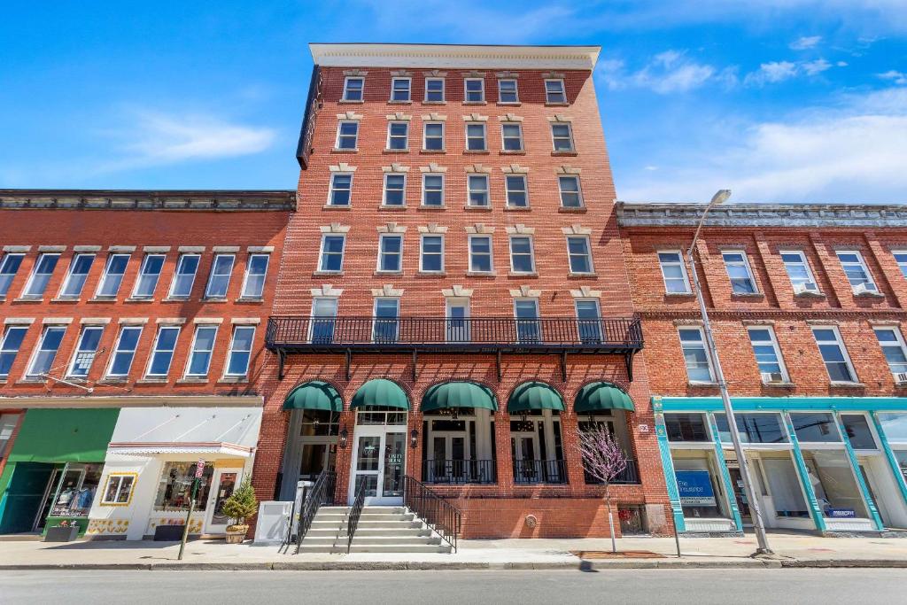 a large brick building on a city street at Tygart Hotel, Ascend Hotel Collection in Elkins