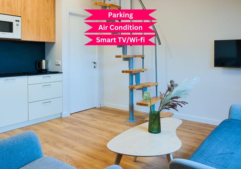 a living room with a vase of flowers on a table at Cosy Studio in the City center with Air conditioneer! in Klaipėda