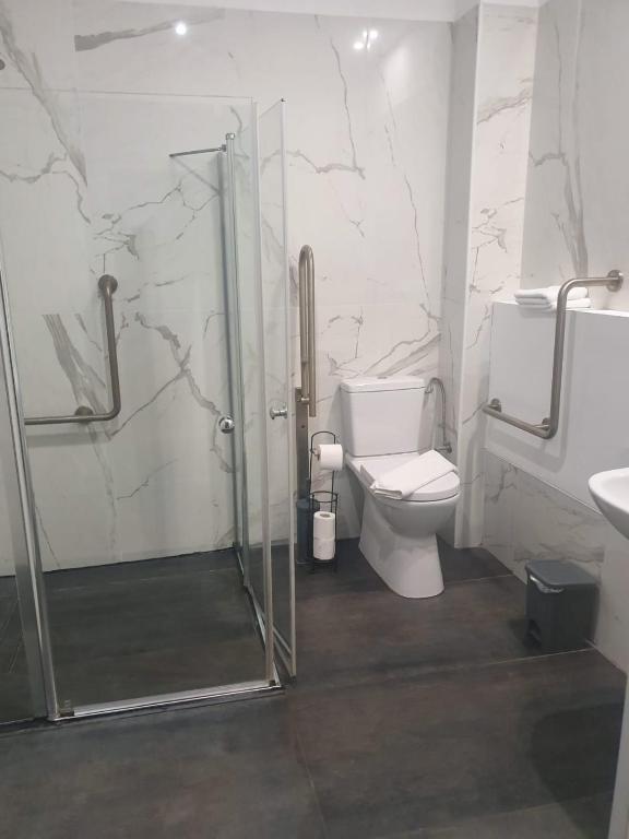 a bathroom with a shower and a toilet and a sink at Sun Sea Center in Eilat