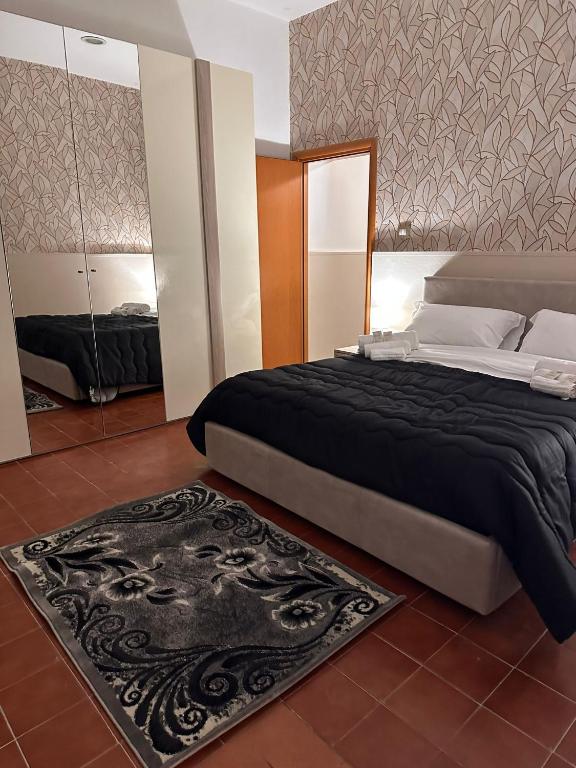 a bedroom with a large bed and a rug at La casetta di Ludovica in Siracusa