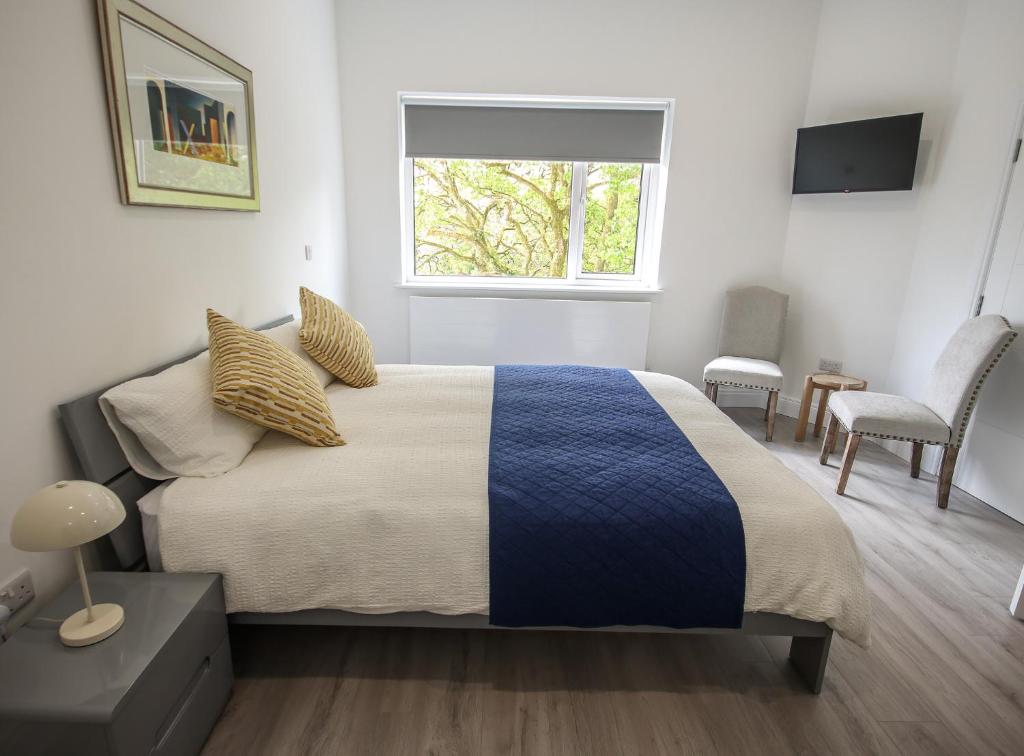 a bedroom with a bed and a window in it at Carrick Gate in Carrick