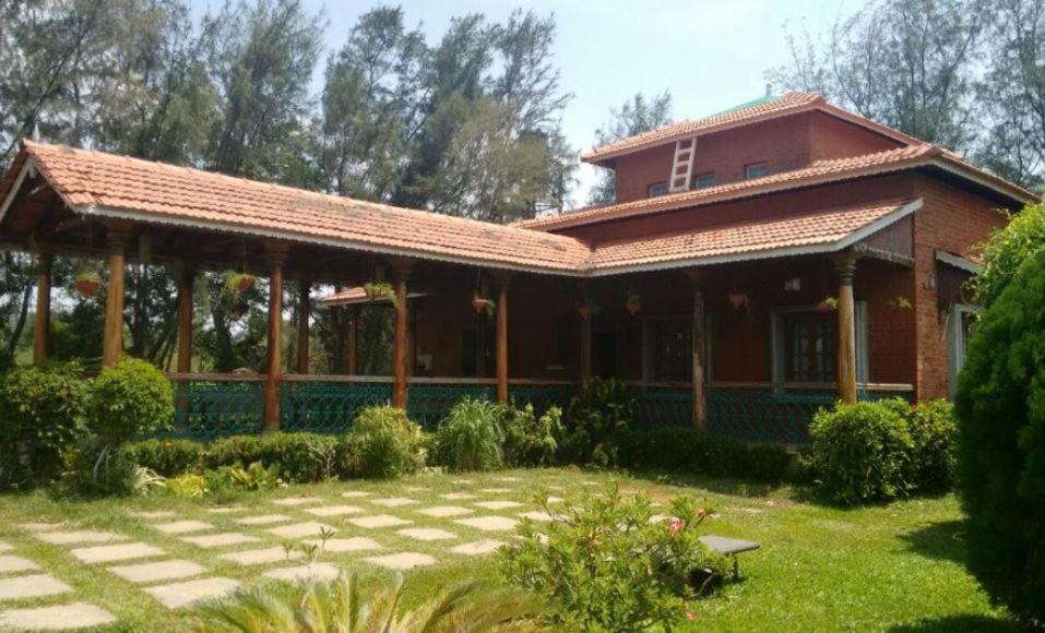 a brick house with a pavilion in a yard at Royal Experiences Chettinad Sea Side Villa, Kanathur ECR Chennai in Chennai