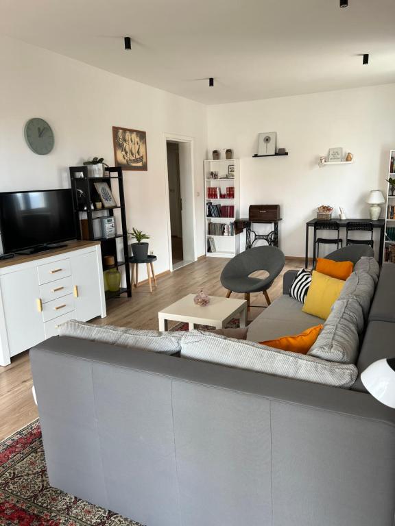 a living room with a couch and a tv at Apartments Romano in Dubrovnik