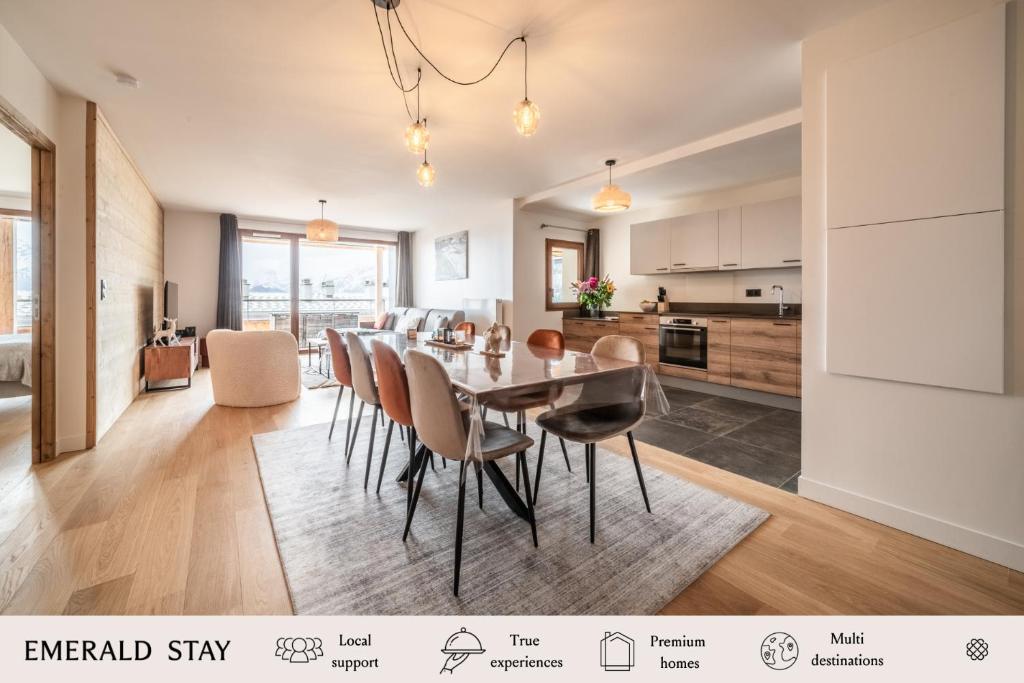 a kitchen and dining room with a table and chairs at Apartment Epicea Alpe d'Huez - by EMERALD STAY in L'Alpe-d'Huez