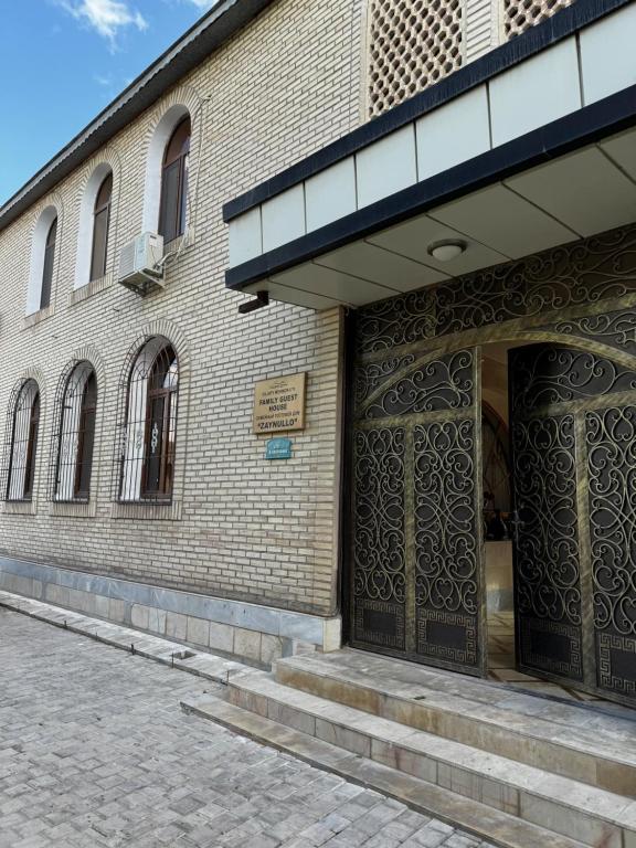 an entrance to a building with a large wooden door at Zaynullo Guest House in Bukhara