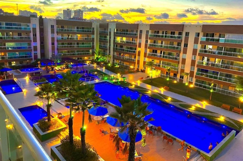an overhead view of a large building with a pool and palm trees at VG FUN Praia do Futuro Pé na Areia ap 311 IMOB TEMPORADA in Fortaleza