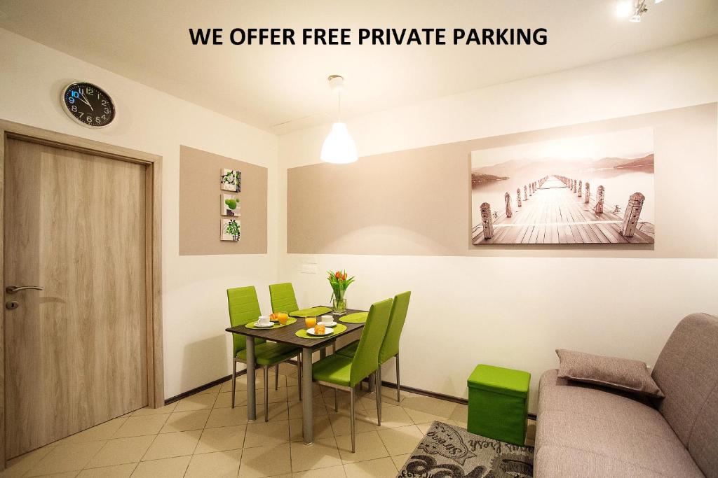a dining room with a table and green chairs at Sweet apartments with free private parking in Ljubljana
