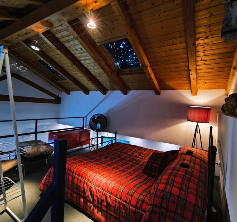 een slaapkamer met een bed, een ladder en een raam bij Loft House in Catania