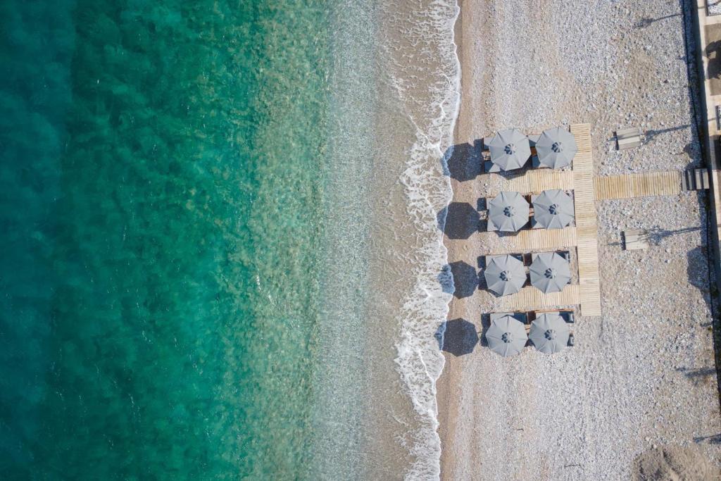 an overhead view of a beach with umbrellas at Tyros Boutique Houses Villas in Tyros