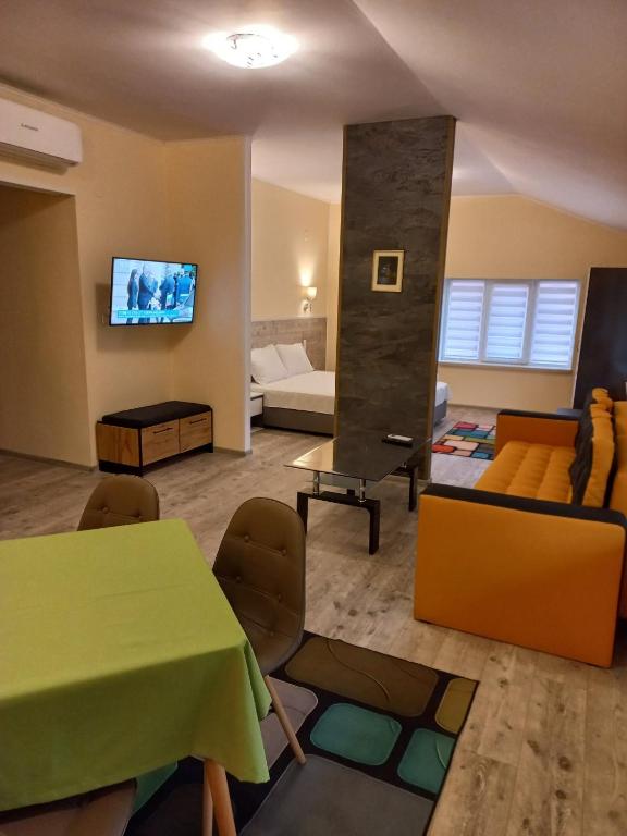 a living room with a green table and a couch at стаи за гости TODA in Troyan