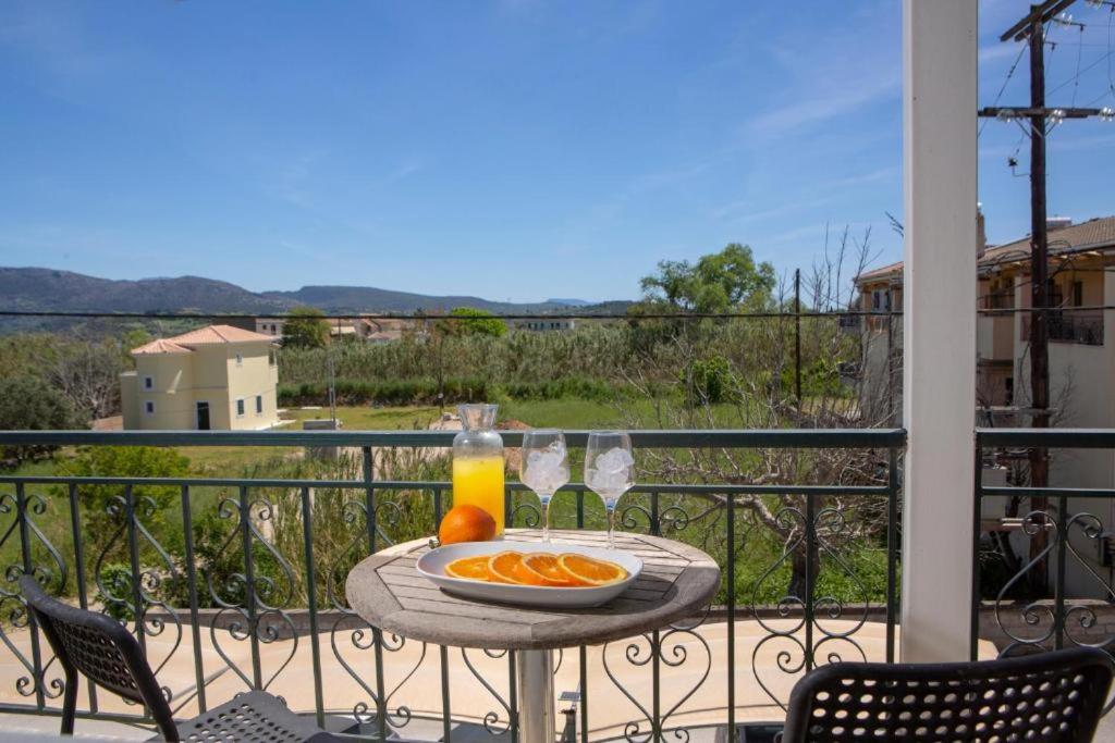 a table with a plate of oranges on a balcony at Casa Hara2 in Lefkada Town