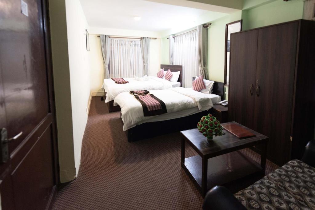 Postel nebo postele na pokoji v ubytování Yeti Cozy Hotel