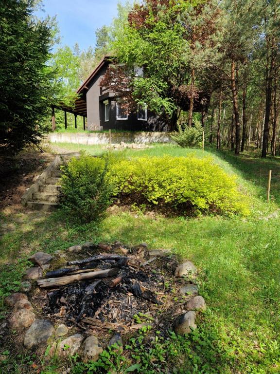 a pile of rocks in front of a house at Całkiem Klawa Enklawa in Brzozie