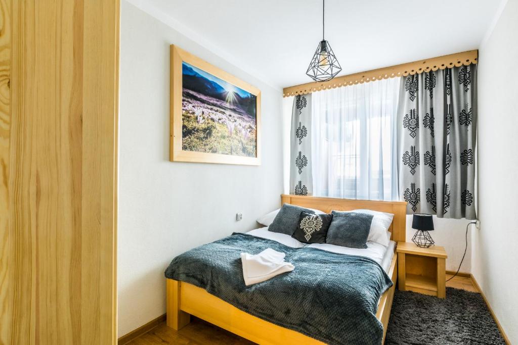 Posteľ alebo postele v izbe v ubytovaní Apartament Regionalny Centrum